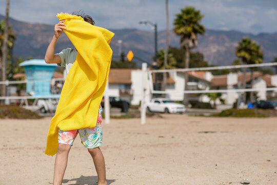 Boy and yellow beach towel