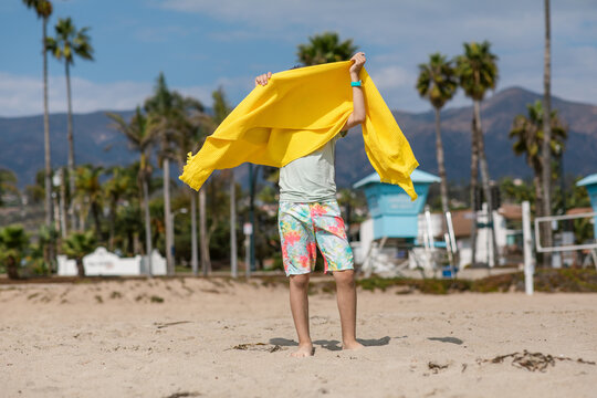 Boy drying off with beach towel