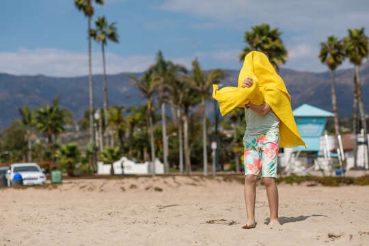 Teen using towel at the beach