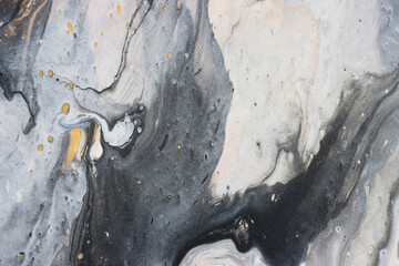 art photography of abstract marbleized effect background with gold, gray, black and white creative colors. Beautiful paint.