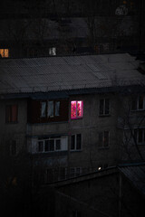 Fototapeta na wymiar the window glows red in the house