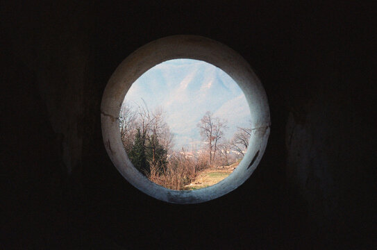 A beautiful round window in the Italian mountains 