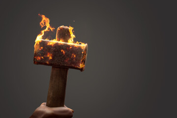 Old iron hammer on fire with copy space