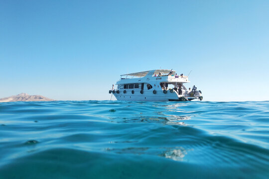 Egypt, Hurgada - February 16, 2020: White yacht sailing on blue turquoise sea water.
