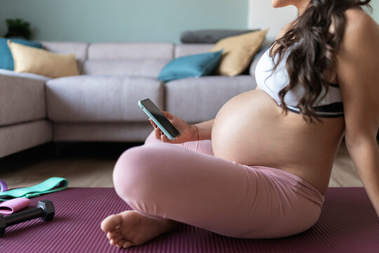 Portrait Of Pregnant Woman Using Phone At Home