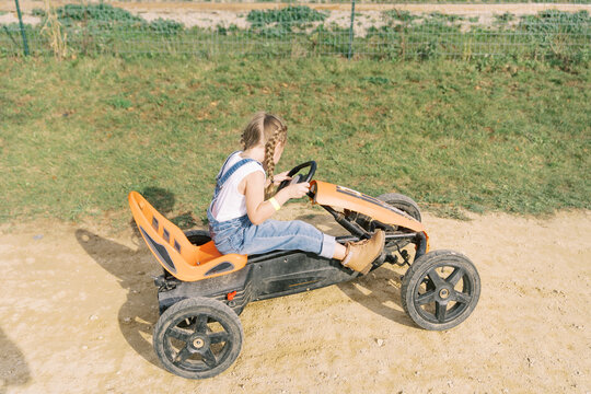 farm girl rides go cart - horizontal