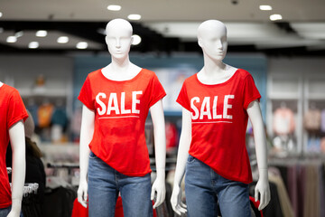 Mannequins in the store with the inscription SALE.