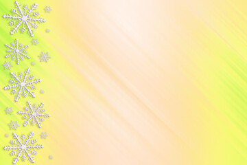 Winter green yellow pink saturated bright gradient background with random snowflakes sideways and with diagonal light stripes. Christmas, New Year card with copy space.