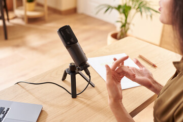 Woman recording podcast in modern mic