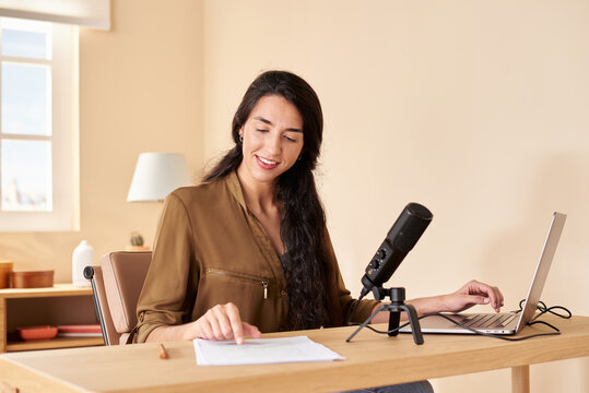 Woman reading notes for podcast