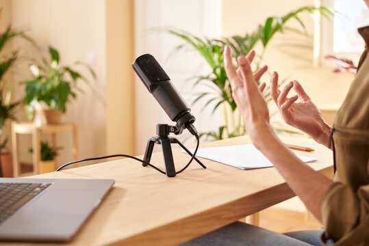 Radio host recording podcast and gesturing