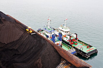 Various views of vessels and tugboats in port. Close-up view of the ships and barges construction....