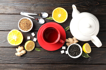 Obraz na płótnie Canvas Concept of hot drink with tea on dark wooden background