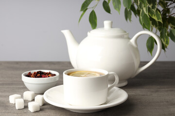 Concept of hot drink with tea on gray wooden table