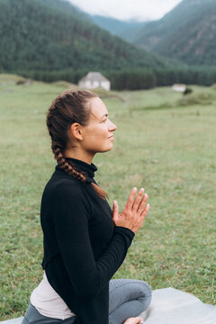 Woman doing yoga with Namaste gesture