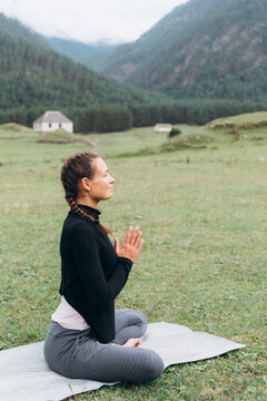 Woman doing yoga with Namaste gesture