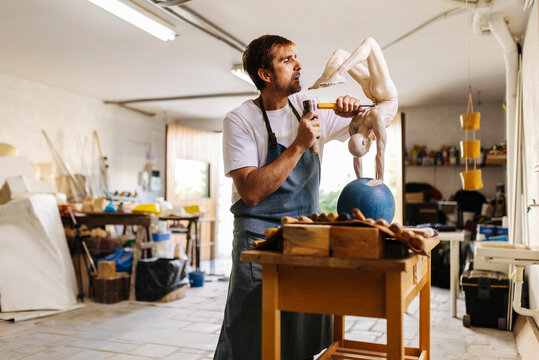 Concentrated artisan working in workshop