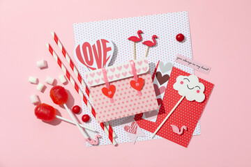 Valentine's Day accessories on pink background, top view