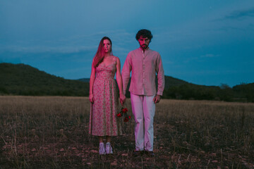 Scary couple in an emty field at night