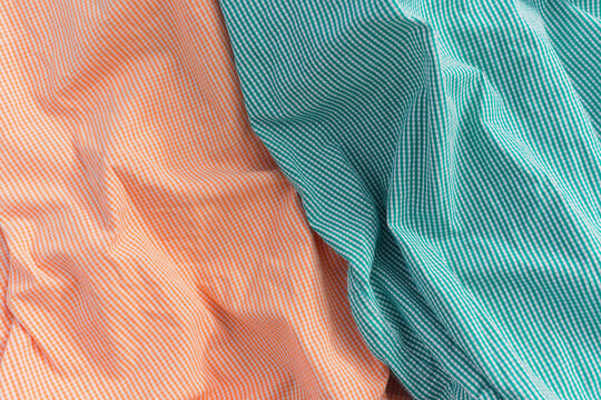 Close-up of orange and mint shirts.