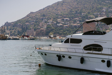 Fototapeta premium Alanya, Turkey - 24 July 2021: Sea pier port for yachts and boats in marina on a background of mountainous terrain. Sea coast