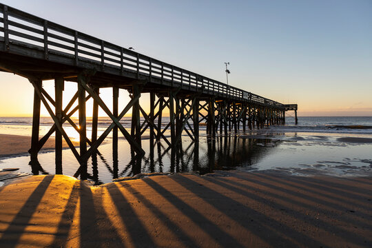 Fototapeta Puddle under Ocean Pier on Beach in South Carolina