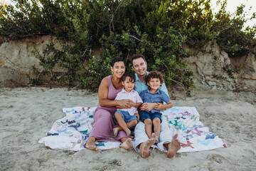 Family portrait sitting on beach