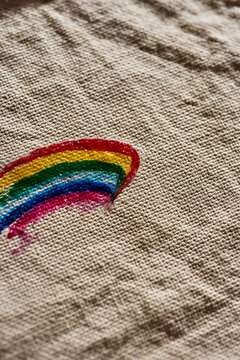 rainbow flag painted on a beige fabric