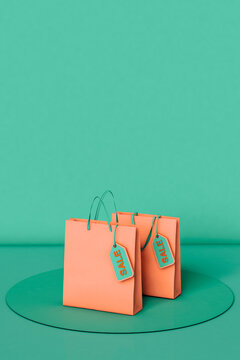 3D render of Shopping bags with a sale tag on green