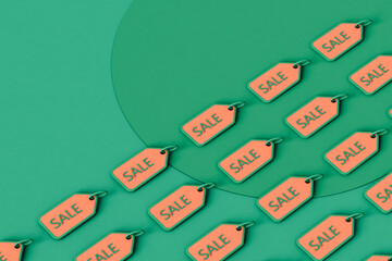 Sale tags. holiday price reduction concept on green