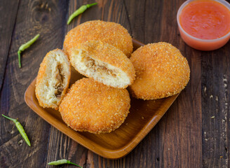 fried bread filled with tuna fish on plate