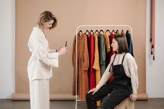 Woman taking photo of creative dressmaker