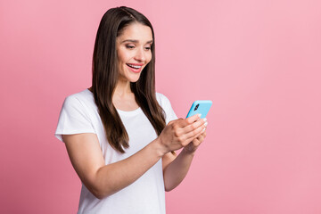 Photo portrait young woman biting nail using mobile phone browsing internet isolated pastel pink color background