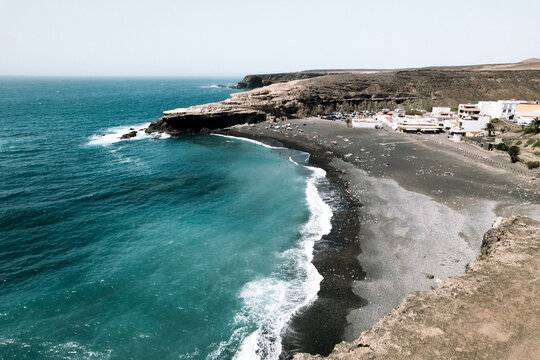 Waving sea washing sandy dark shore