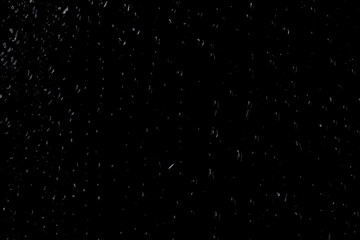 Water drops on glass on a black background.