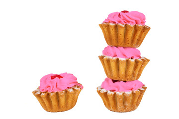 Beautiful sweets. Cakes basket with pink cream decorated with red berries on a white plate.