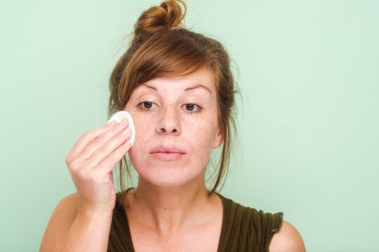 Woman With Freckles Doing Facial Cleansing