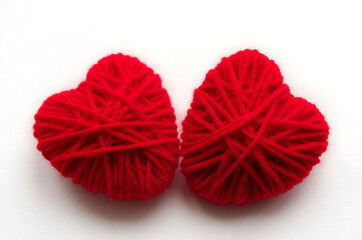 Two red hearts of yarn close-up on a white background valentine's card for valentine's day