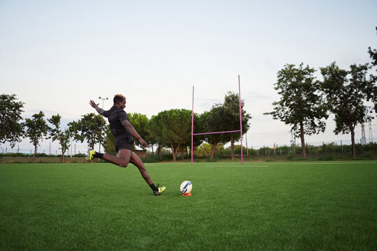 Black rugby player exercising in field