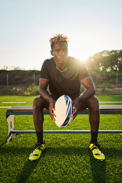 Black sportsman with rugby ball