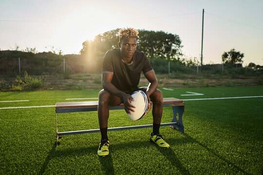 Black sportsman with rugby ball