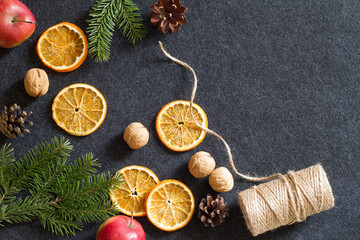 Christmas background, dried orange, cones, nuts and apples, natural decorations for christmas tree