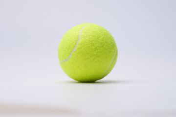 Bright lime tennis ball on white background closeup