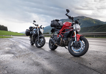 Fototapeta na wymiar motorcycle on the side of a rural mountain alpine road