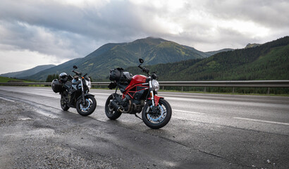 motorcycle on the side of a rural mountain alpine road