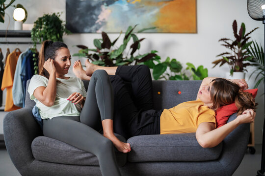 Diverse girlfriends chatting on couch