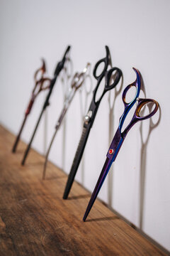Various scissors on wooden table