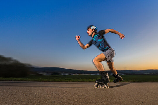 Confident man skating on road during sunset