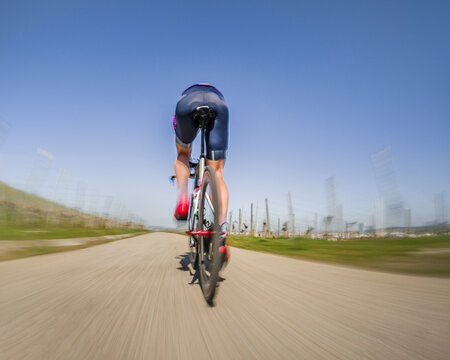 Young man riding cycle on road