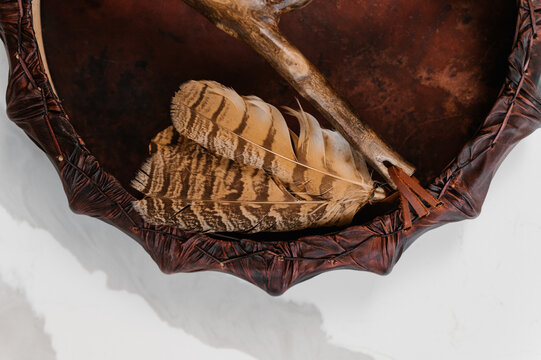 Shaman tambourine and drumstick on table
